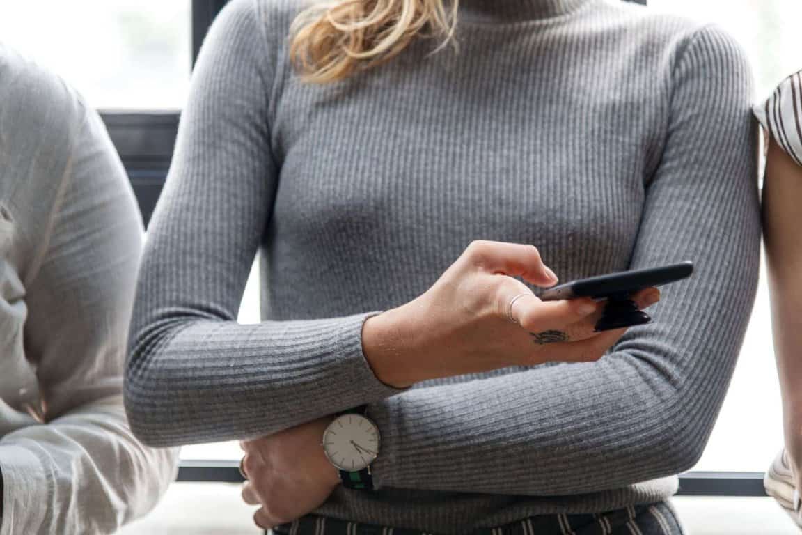 A woman checks her mobile phone.