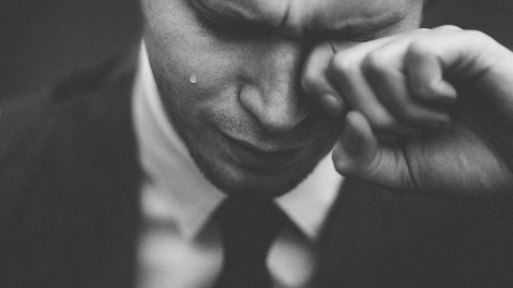 depressed man in suit crying