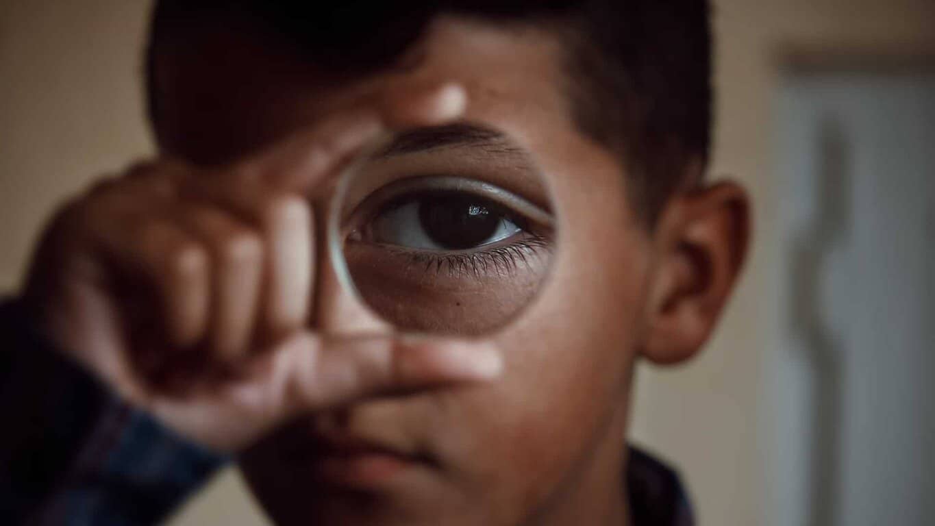 Little boy holding magnifying glass