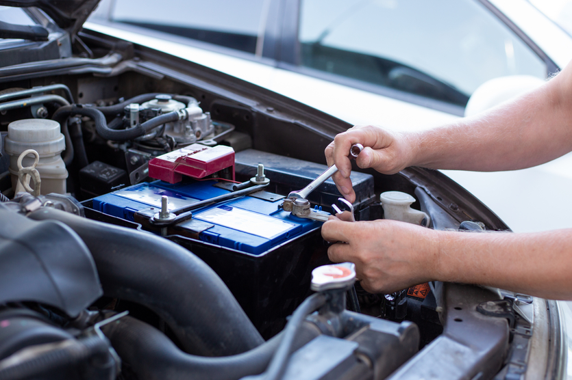 person working on car battery